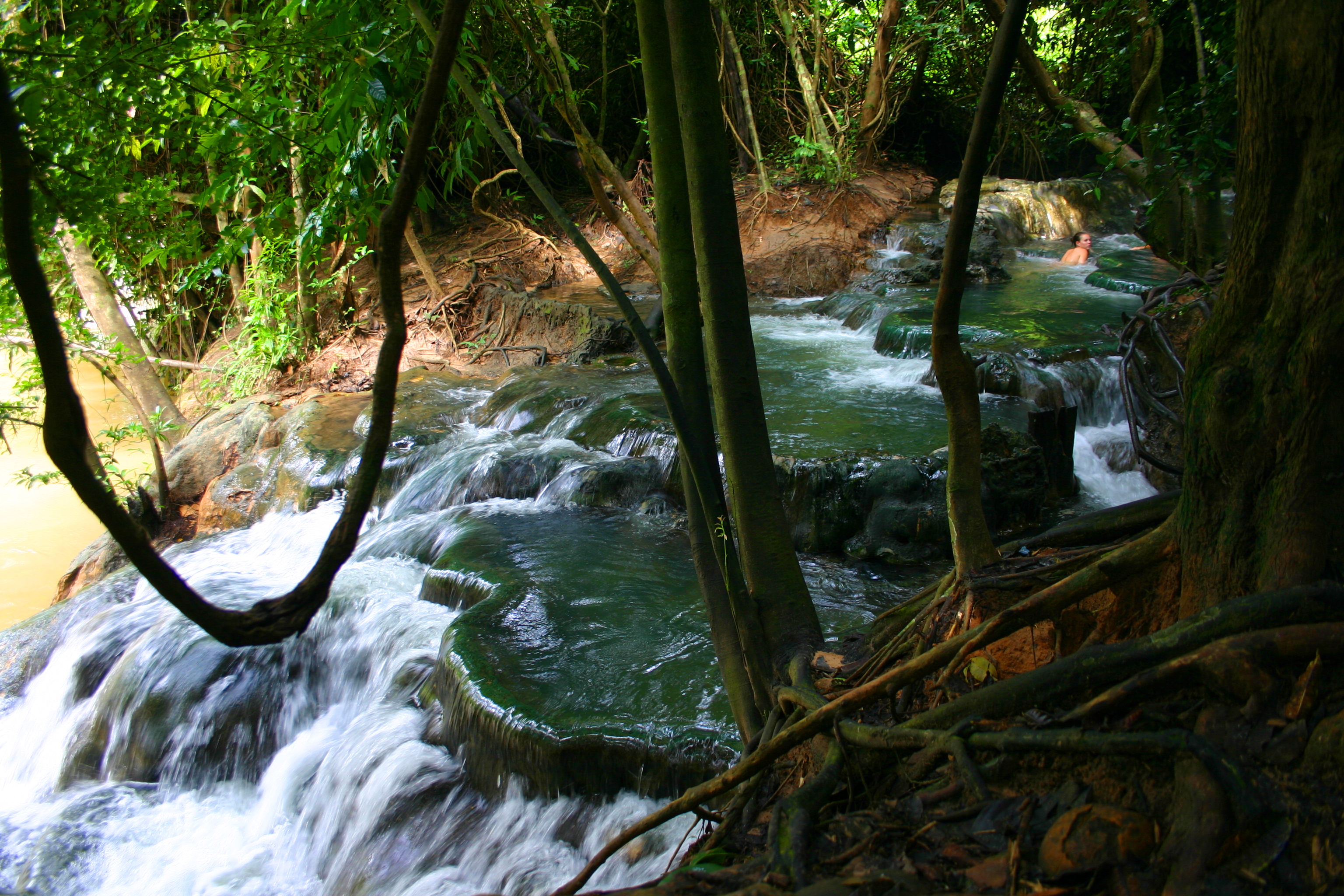 Water cascades over some naturally formed tubs.